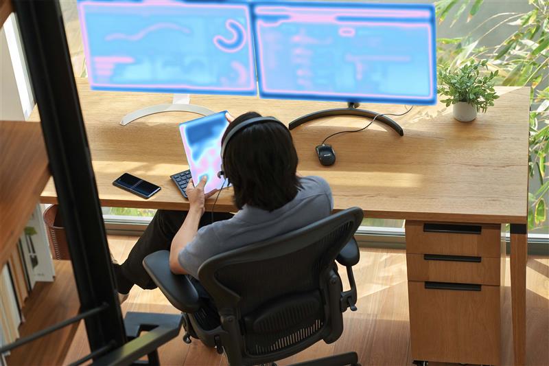 a person sitting at a desk with a computer